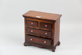 An oak and mahogany apprentice chest of two short and two long drawers, mahogany drawer fronts
