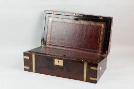 A nineteenth century flame mahogany writing slope with brass and ebony banding nameplate and