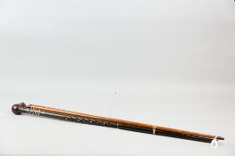 An Indian hardwood and bone dot inlaid (some losses) walking cane with ball shaped grip and a