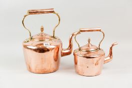 A large Georgian copper kettle with brass acorn knop and a smaller Victorian brass kettle with acorn