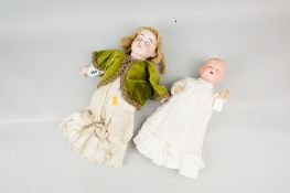 An Armand Marseille bisque headed doll in the form of a baby with rolling blue eyes and open