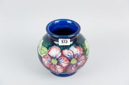 A Moorcroft pottery globular vase, a predominantly cobalt blue bodied vase with tube line decoration