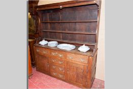 A late 18th Century flat fronted oak Welsh dresser, the three shelf rack with shaped sides (pot