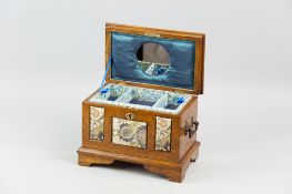 An Edwardian oak jewellery chest with metal carrying handles on bracket corner feet, the sarcophagus