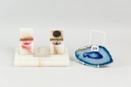 An early twentieth century onyx desk stand with twin lidded ink pots, the hinges marked H, G & S,