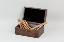 A small rosewood box used as a cigar box containing a parcel of cigars
