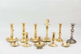 A large parcel of mixed brass chambersticks and candlesticks