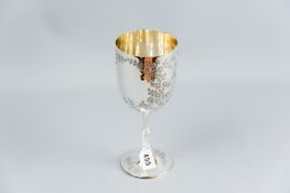 A circular based uninscribed silver trophy cup with bright cut all round floral decoration, 8.5 ozs,
