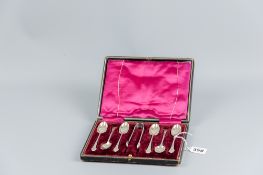 A cased set of six silver coffee spoons and tongs with fan shaped handles, 2.2 ozs, London 1898