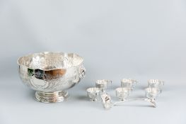 A large bright cut electroplated punch bowl with lion's mask and ring handles to a patterned