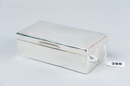 An oblong plain silver cigarette box with inscription to the outside of the lid, London 1929