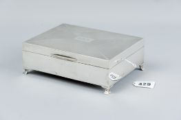 An oblong silver cigarette case of wide form with engine turned lid (initialled) and on corner
