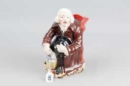 A circa 1820 Staffordshire pearlware jug modelled as a seated night watchman, 24 cms high (losses to