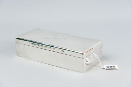 A large oblong plain silver cigarette box with inscription to the lid, London 1892