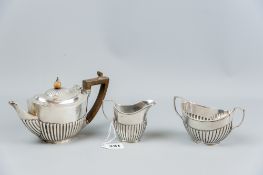 A three piece silver bachelor tea service, each piece of oval form with half reeded decoration, 12.5