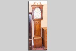 A 19th Century oak longcase clock, the arched hood with a circular painted dial, eight day