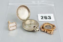 A yellow metal seal fob, a nine carat gold mounted compass pendant and a white metal compass