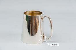 A plain silver mug of slightly tapered form, 8.3 ozs, Birmingham 1911