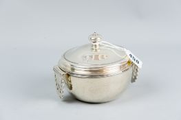 A circular silver posset pot with scrolled and pierced hinged handles, 4 ozs total, London 1816