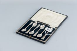 A cased set of six silver coffee spoons with scrolled and shaped handles, Sheffield 1932