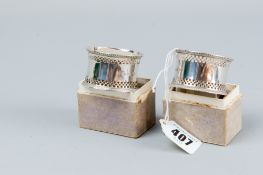 A pair of boxed silver napkin rings, each having a double pierced band, 1 oz, Birmingham 1921, in
