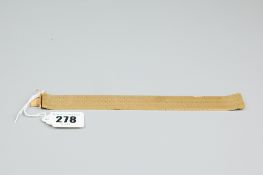 An eighteen carat gold bracelet, 2 cms wide, 19 cms long, the pattern of seven rows of hexagons,