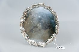 A circular silver letter tray with stepped and wavy border, 8 ins (20 cms) diameter, presentation