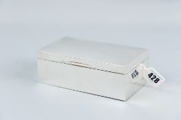 An oblong plain silver cigarette box with corner inscribed initials and date, London 1923