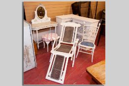 A white painted cane backed and cane seated folding steamer chair, a pair of white painted single