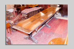 An early 20th Century oak side or dining refectory table on three large carved pineapple supports