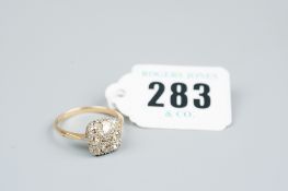 An eighteen carat gold dress ring having a large square cluster of eight graduated diamonds, 3.7