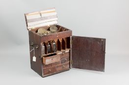 An early 1800's mahogany apothecary cabinet with hinged lid and front and rear opening doors, all