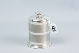 A brass and bakelite carousel cylindrical cigarette dispenser, the outer casing of engine turned