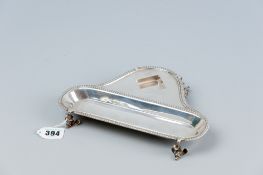 A silver desk stand (bottle missing), the piece having a gadrooned border and on four animal head