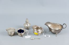 A silver cream boat on three web supports and a small plain silver cream jug, Birmingham 1914 and