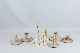 A parcel of electroplated chambersticks and candleholders