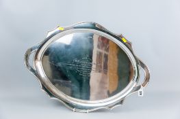 A large oval silver twin handled tray having a wavy border and the 'handles' of pierced form as part