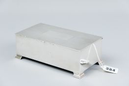An oblong plain silver cigarette box with engine turned lid and corner bracket feet, London 1947