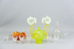 A pair of vaseline lily vases on circular bases with decorated columns, a green carnival glass