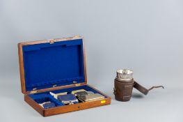 An electroplated hunting flask and two beakers, all in a leather case, an all metal electroplated