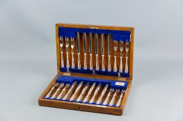 A polished encased canteen of, possibly silver handled, all metal fruit knives and forks in their