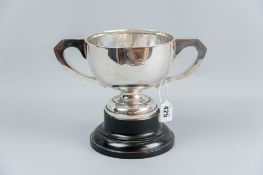 A silver trophy cup of plain form with two handles on a plinth, uninscribed, 14.5 ozs, Birmingham
