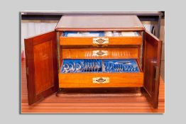 A fine two door mahogany canteen of electroplated cutlery contained in five interior narrow