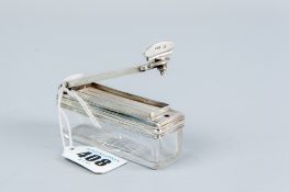 An oblong glass snuff container with star cut base and having a silver rim and a silver hinged top