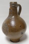 A good seventeenth century Belamine bottle with mask and cameo decoration, 8ins high (20cms)