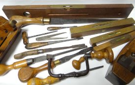 A good collection of antique carpentry tools including brass mounted spirit levels, planes,