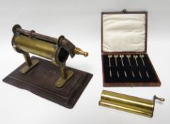 An antique brass mounted tobacco cutter, a set of silver gilt cocktail sticks with cockerel