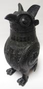 A Chinese bronze stylised owl wine vessel with lift-off lid and standing upon two feet and its tail,