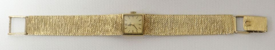 An Omega 9ct yellow gold ladies wristwatch having a square dial to the tapered textured bracelet,