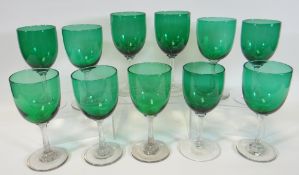 Eleven Victorian green glasses with clear stems and feet